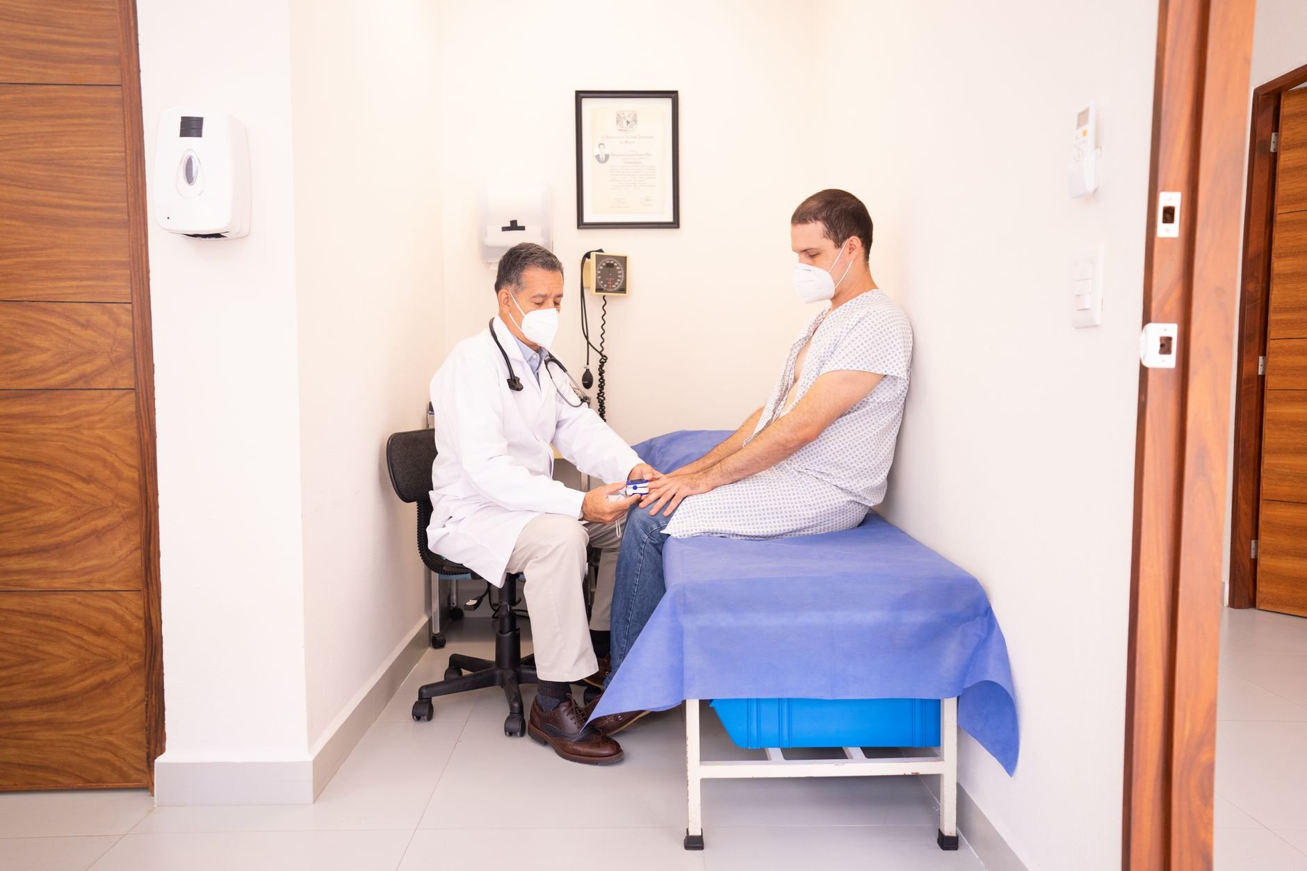Doctor checking patient vitals in a clinical consultation setting